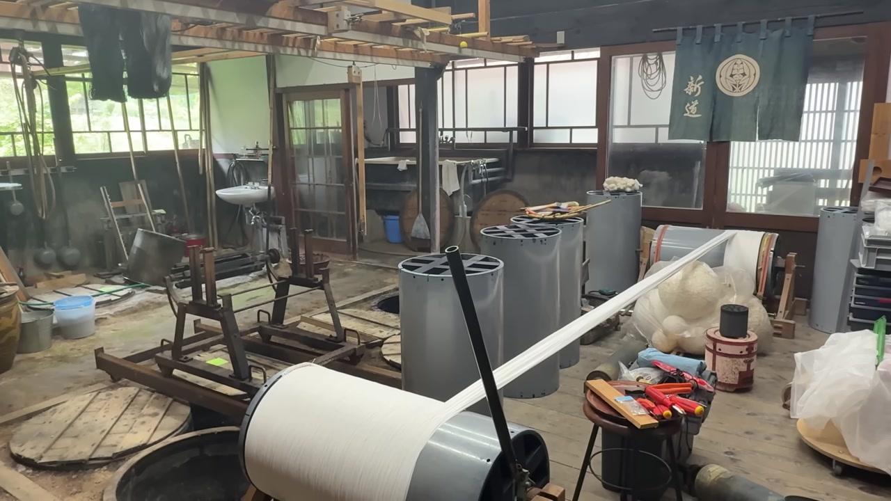 Tấm biển chỉ đường bằng gỗ với nhiều mũi tên chỉ dẫn các hướng khác nhau, nằm giữa một khu vườn đầy hoa và cây xanh.