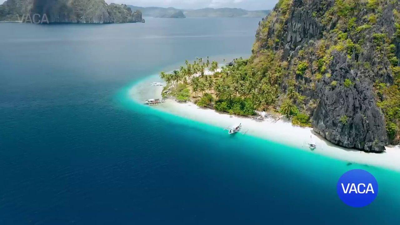 Bãi biển trong xanh tại Công viên Quốc gia Khẩn Định với những tảng đá san hô dọc bờ.